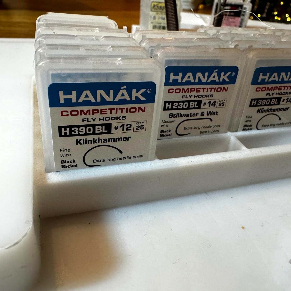 Close-up of Hanak Competition hook boxes in a hooktray