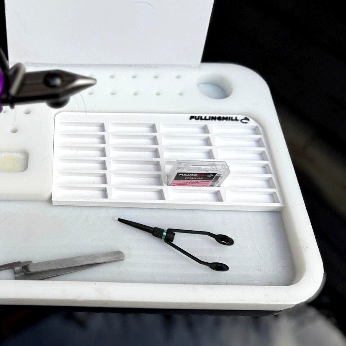 Hooktray dropped into a fly-tying station alongside tools