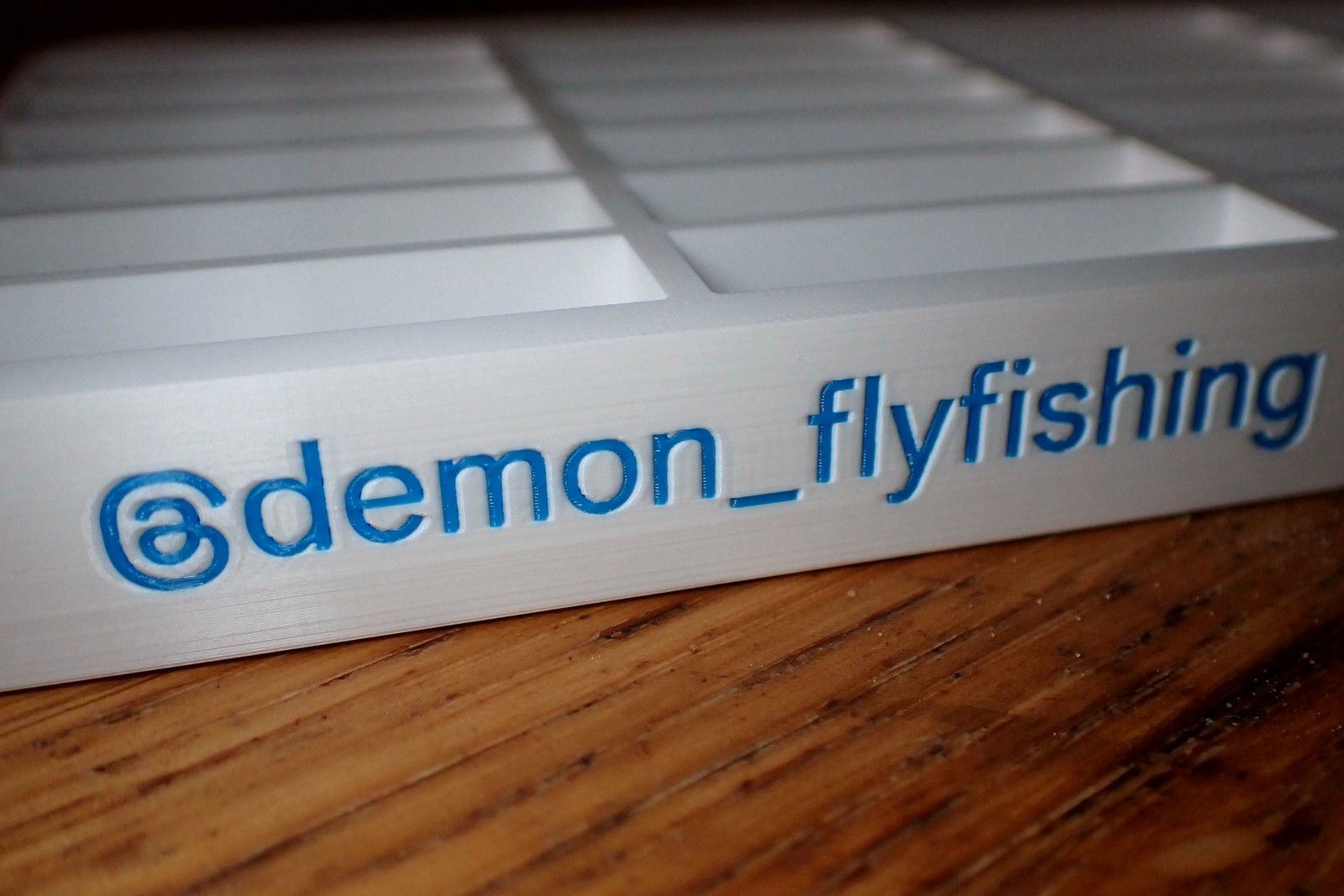 Personalised white fly-tying hook tray with blue @demon_flyfishing lettering, sized to fit Hanak hook boxes